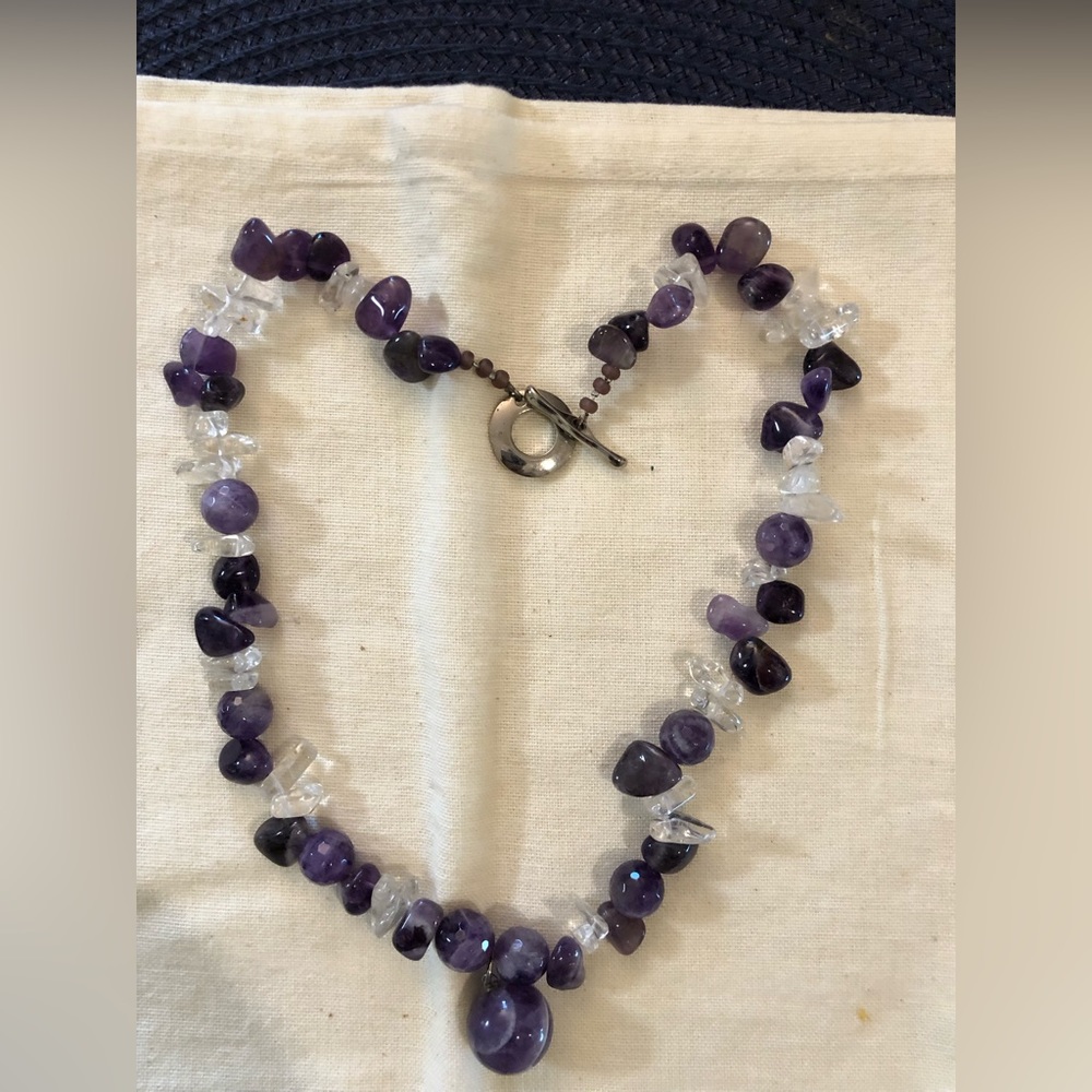 Single strand, amethyst, and clear necklace with amethyst drop